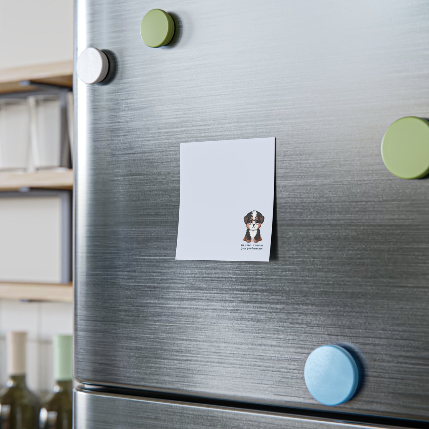 Fridge with a magnet featuring a dog illustration and text, surrounded by colorful magnets.