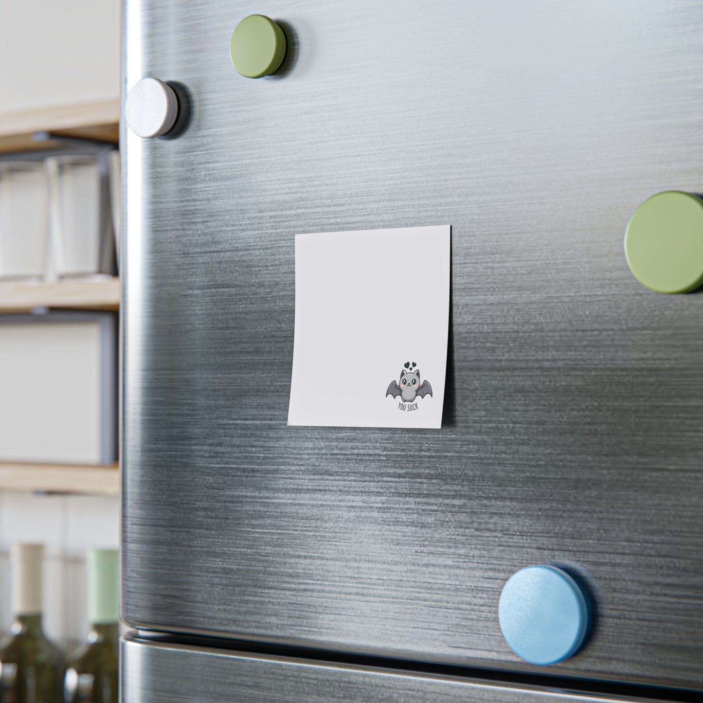 Fridge with decorative magnets and a sticky note