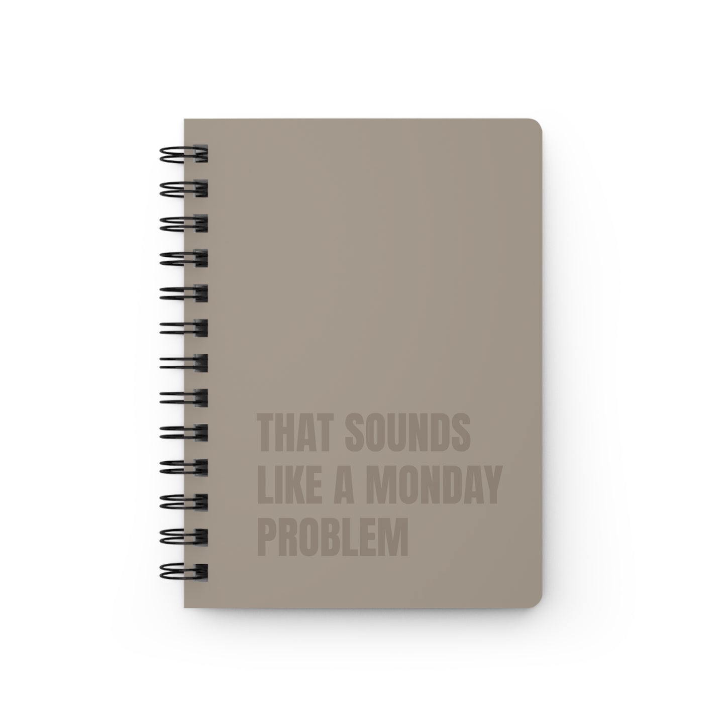 Beige notebook with text 'That sounds like a Monday problem' on a white background