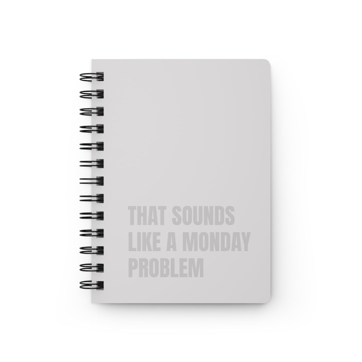 Beige notebook with text 'That sounds like a Monday problem' on a white background
