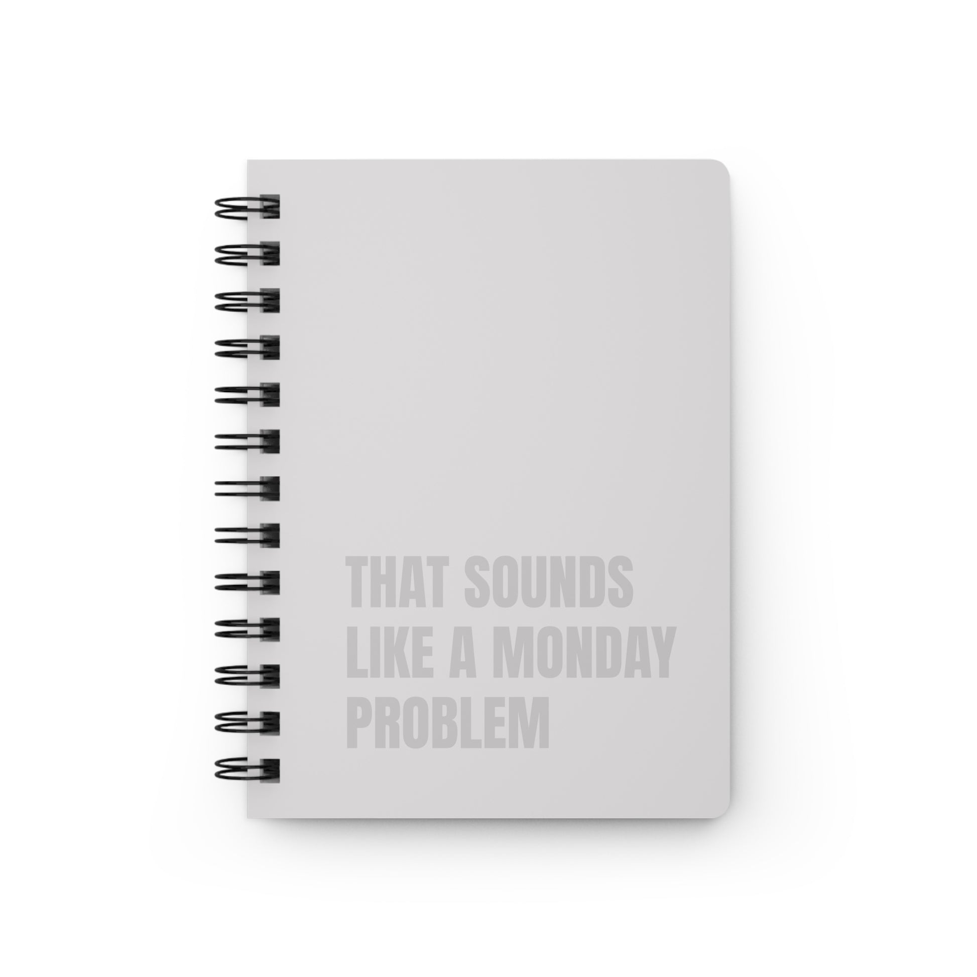 Beige notebook with text 'That sounds like a Monday problem' on a white background
