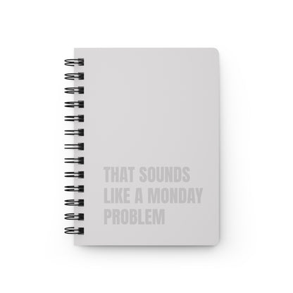 Beige notebook with text 'That sounds like a Monday problem' on a white background