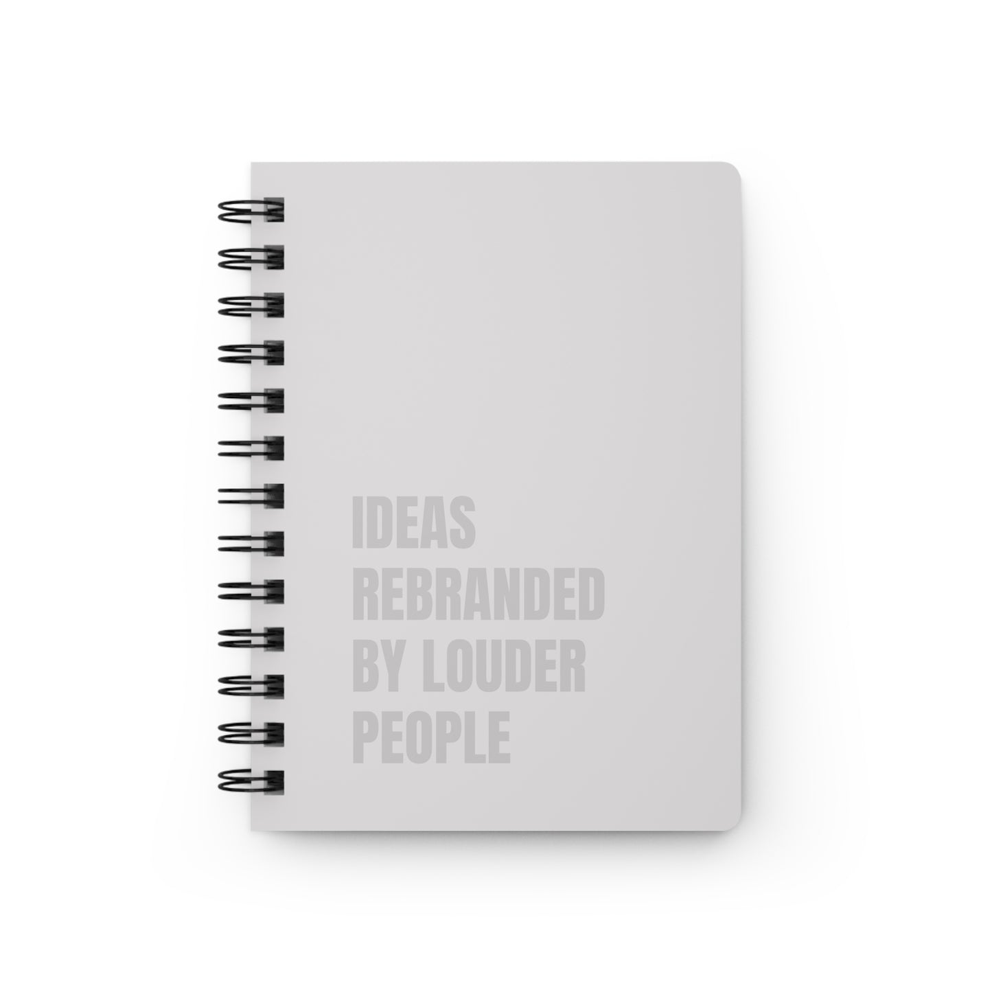 White notebook with black spiral binding and text on a white background