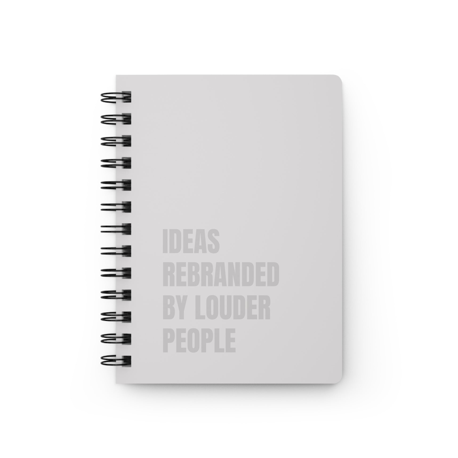 White notebook with black spiral binding and text on a white background