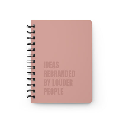 Pink notebook with text on a white background