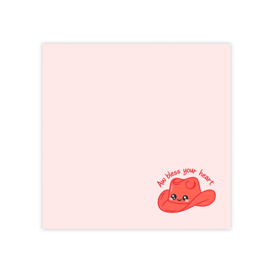 Sticky note with a red heart wearing a cowboy hat and text 'All bless your heart' on a pink background