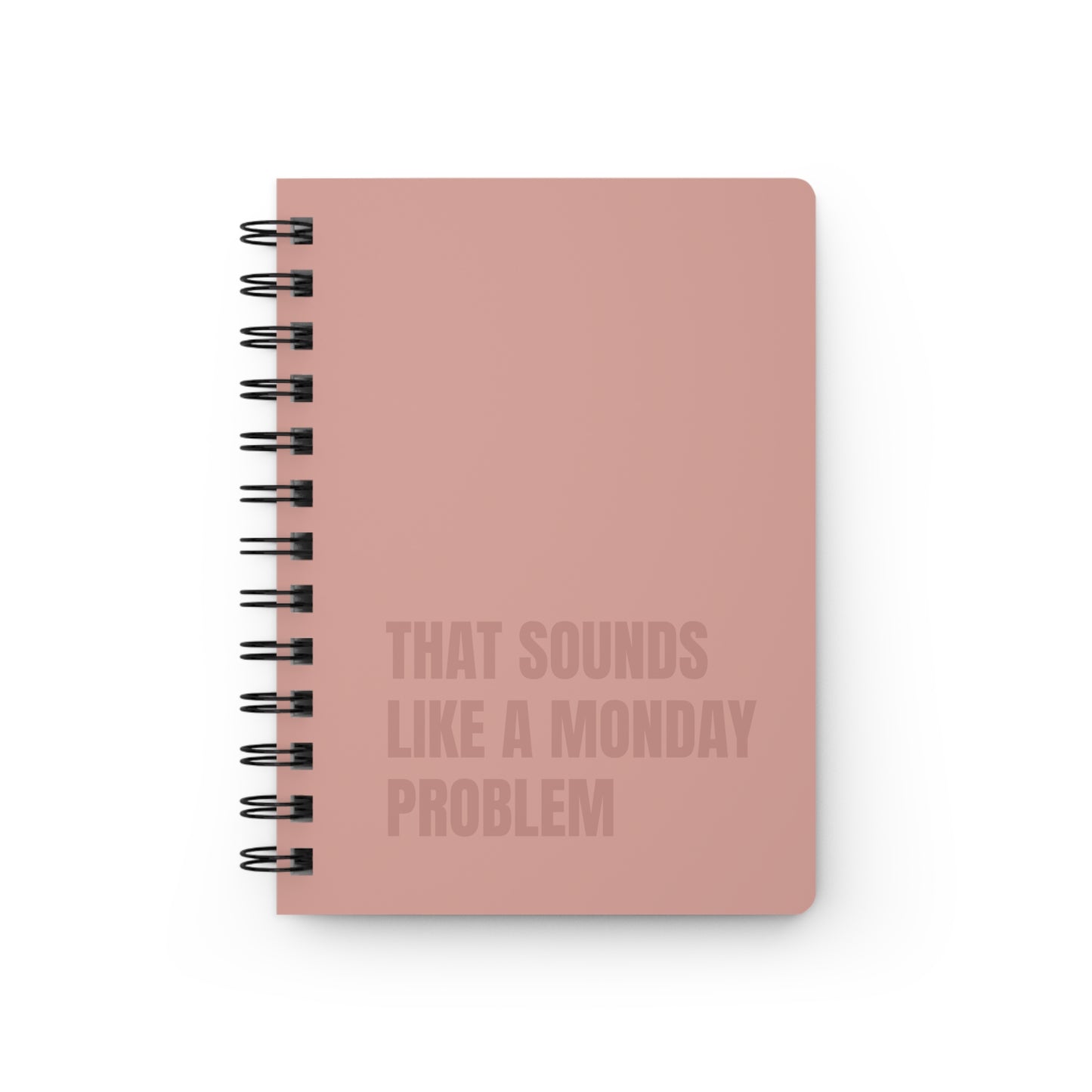 Beige notebook with text 'That sounds like a Monday problem' on a white background