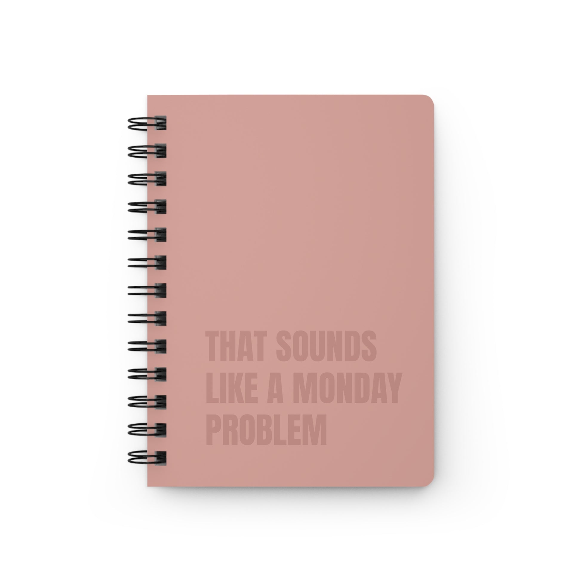 Beige notebook with text 'That sounds like a Monday problem' on a white background