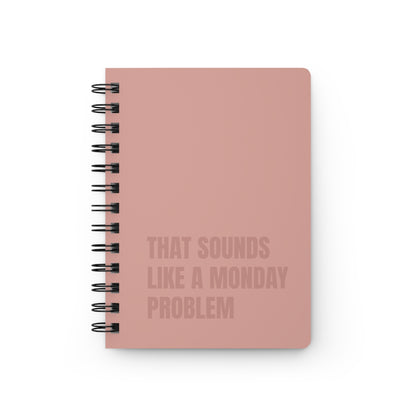 Beige notebook with text 'That sounds like a Monday problem' on a white background