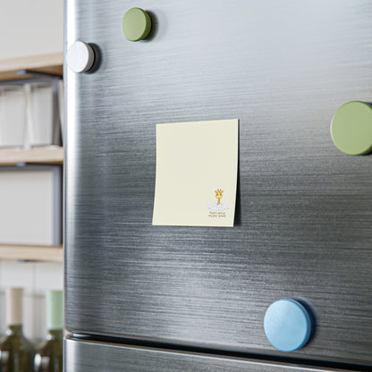 Close-up of a metallic surface with circular magnets and a sticky note.