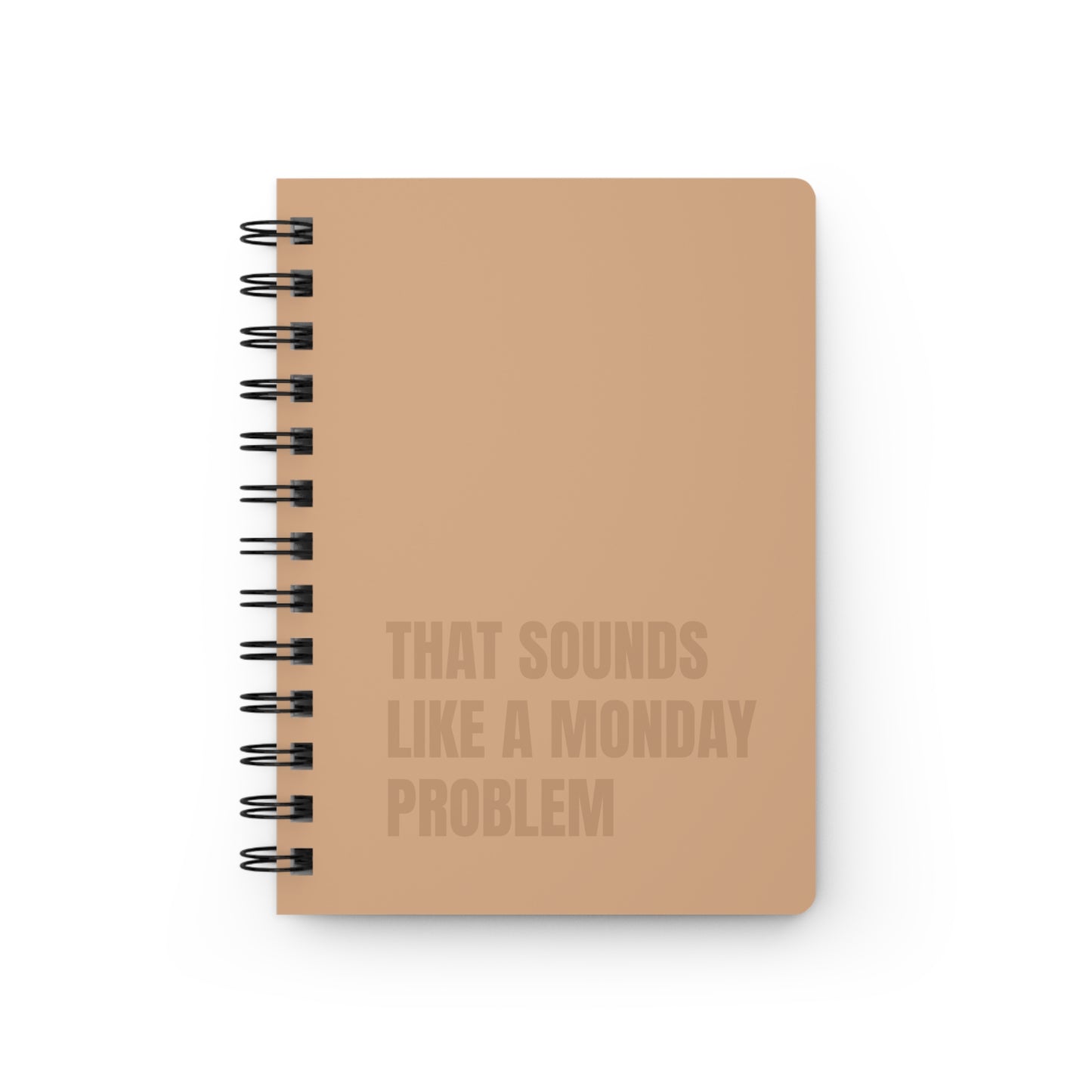 Notebook with text 'That sounds like a Monday problem' on a white background