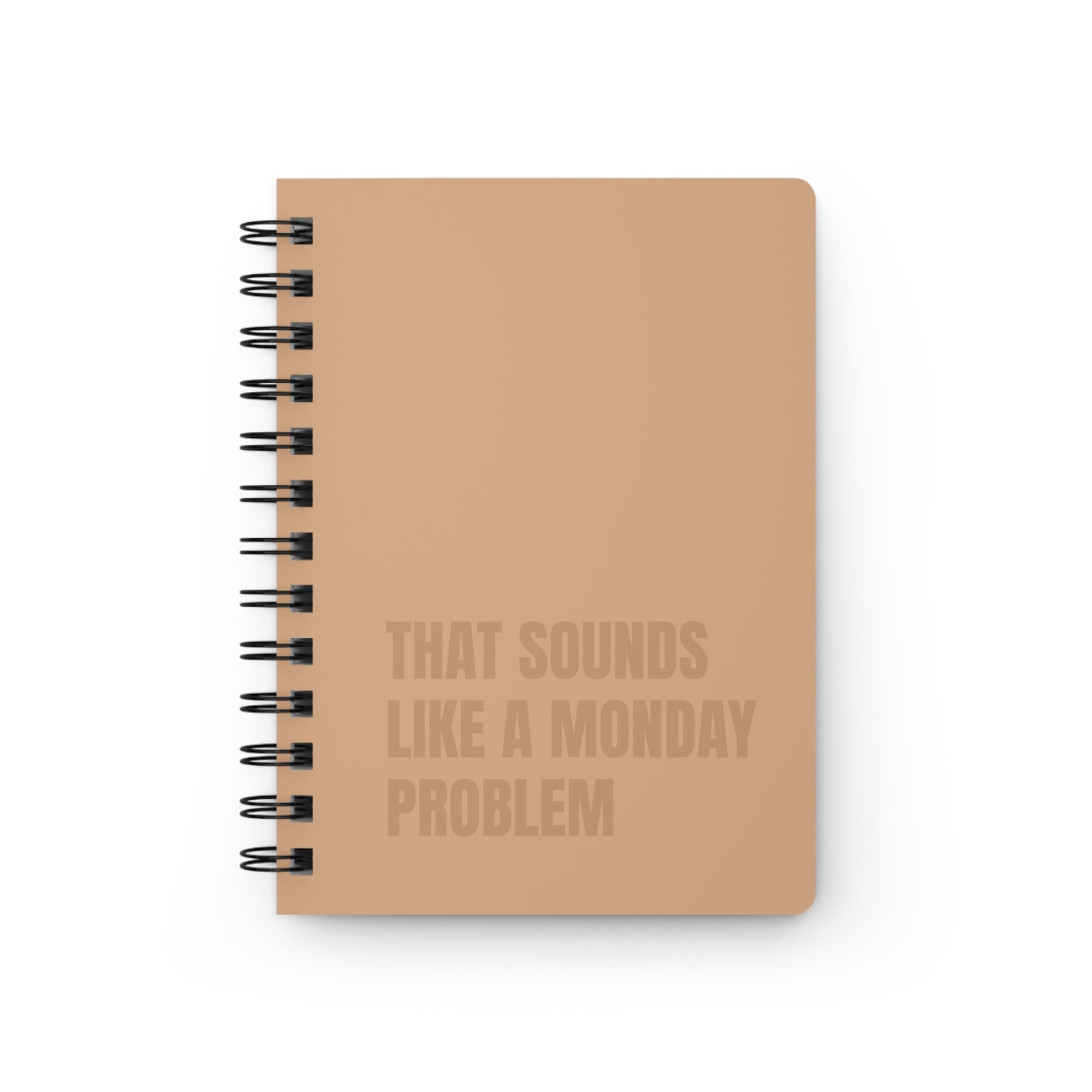 Notebook with text 'That sounds like a Monday problem' on a white background