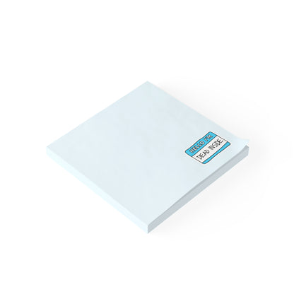 Stack of white sticky notes with a blue label on a white background