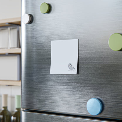Fridge with magnets and a sticky note on a kitchen background