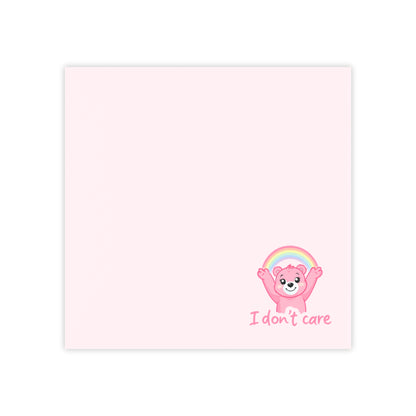 Cartoon bear with rainbow and 'I don't care' text on a pink background