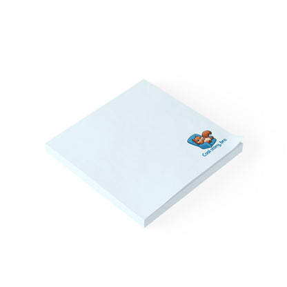 Angled view of a light blue sticky note pad with a cute squirrel design near the corner.