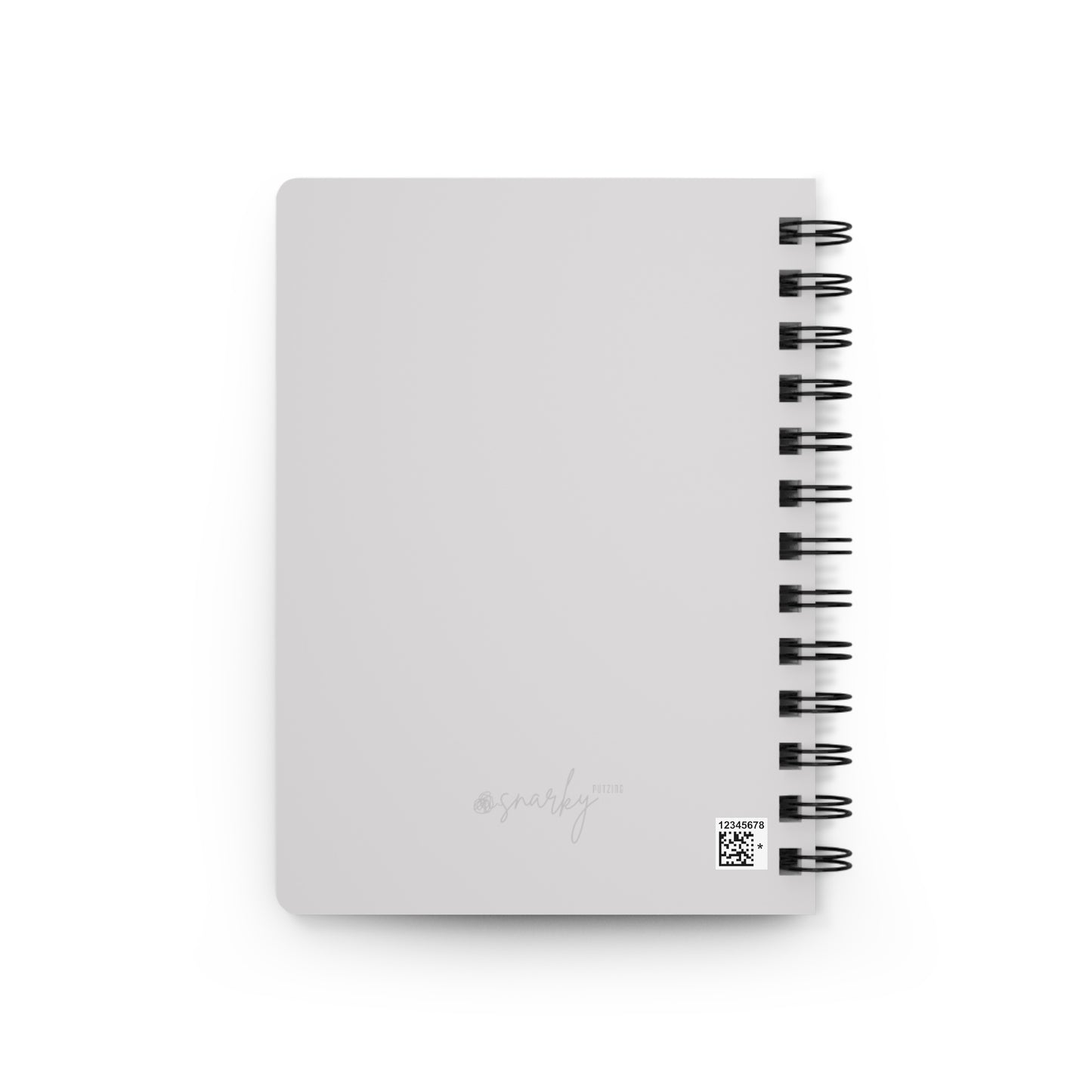 White notebook with black spiral binding on a white background