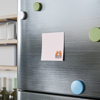 Note with a cat illustration attached to a refrigerator door with colorful magnets.