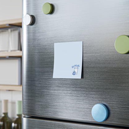 Fridge with magnets and a card on a kitchen background