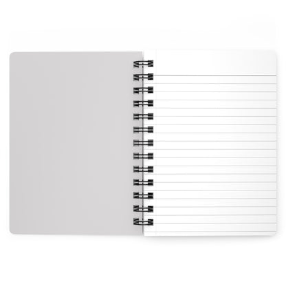 White notebook with black spiral binding on a white background