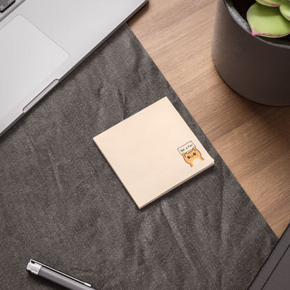 Notebook with a cute illustration on a desk next to a laptop and plant