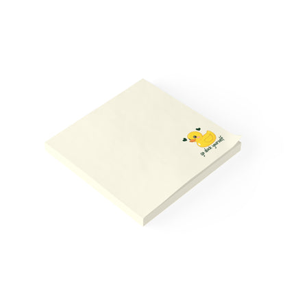 Notepad with a yellow duck illustration and text on a white background