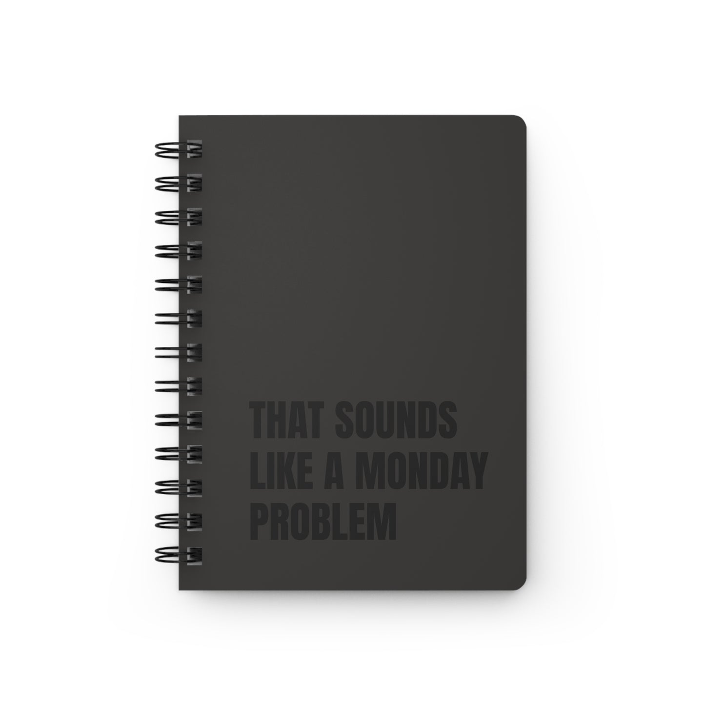 Black notebook with text 'That Sounds Like a Monday Problem' on a white background