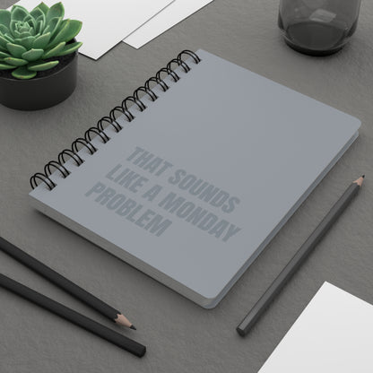 Notebook with text on a desk with pencils and a plant